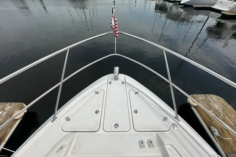 Slide: The Image of Bow view of a 2012 Regal 42 Sport Coupe docked at a marina. - 8