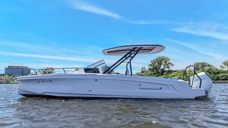 Slide: The Image of A white motorboat on a river with a blue sky in the background. - 12