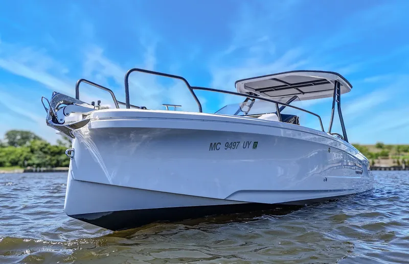 Slide: The Image of A white boat on the water with a blue sky in the background. - 13