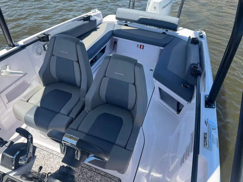Slide: The Image of The boat features two cushioned seats and is situated on calm water. - 16