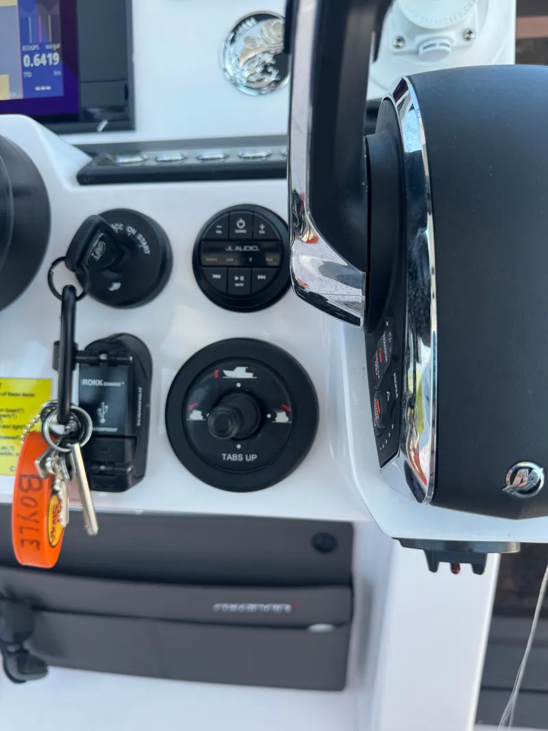 Slide: The Image of Close-up of a boat's control area with keys and controls visible. - 19