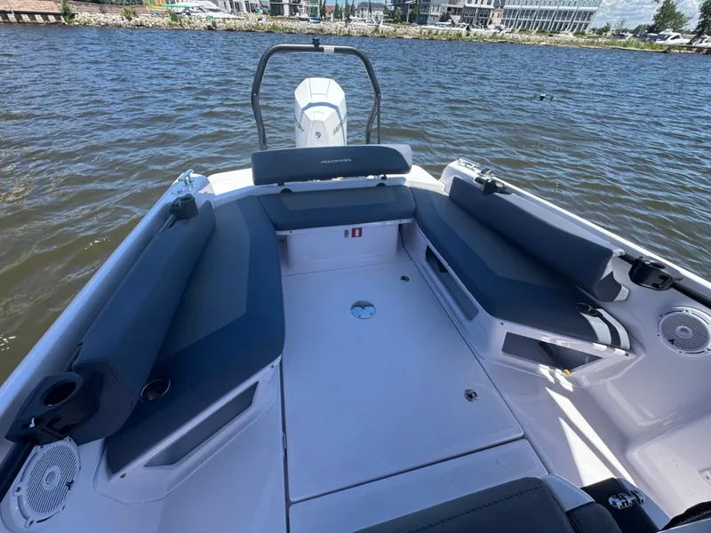 Slide: The Image of The boat features an open seating area with gray cushions, situated on a river. - 20