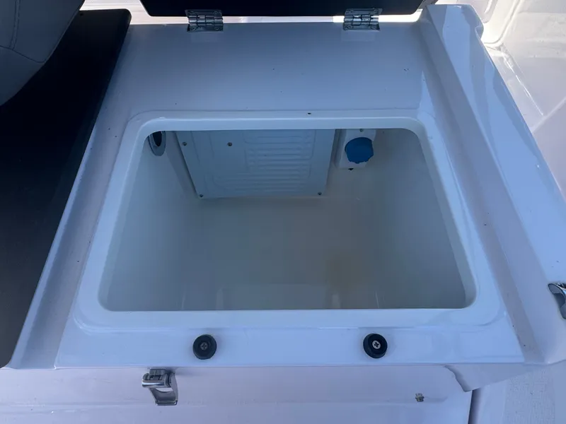 Slide: The Image of An open storage compartment on a boat with a white interior. - 21