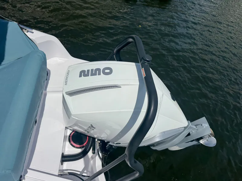 Slide: The Image of A Mercury boat engine on an Axopar boat, floating on the water. - 25