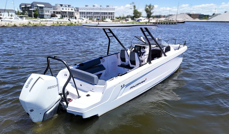 Slide: The Image of A white Axopar boat on calm water, featuring a Mercury engine and modern design. - 7