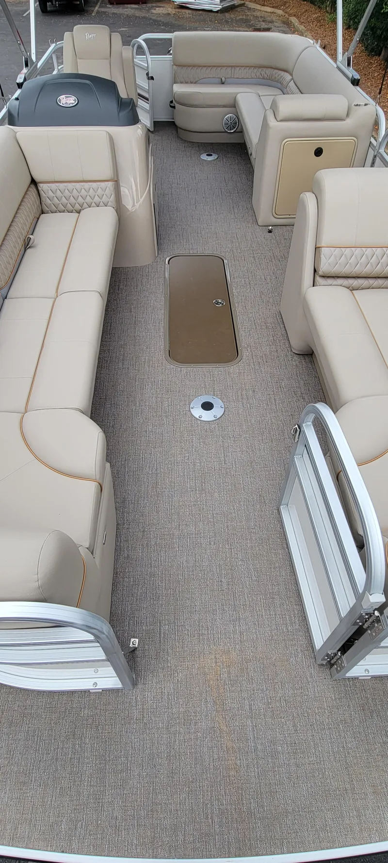 Slide: The Image of Interior view of a Ranger Reata 223C pontoon boat with beige seating and carpeted floor. - 10