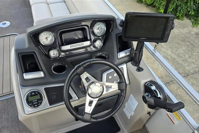 Slide: The Image of 2023 Ranger Reata 223C boat dashboard with steering wheel and navigation system. - 4