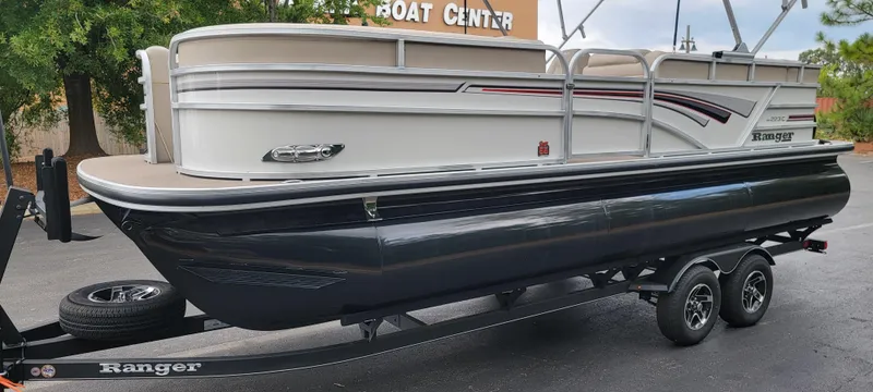 Slide: The Image of A Ranger Reata 223C pontoon boat on a trailer, parked in a lot. - 7