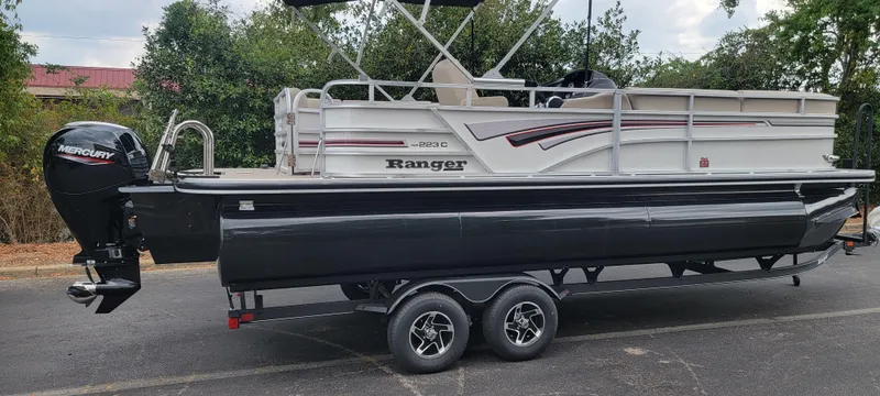 Slide: The Image of A Ranger Reata 223C boat on a trailer, parked on a road. - 9