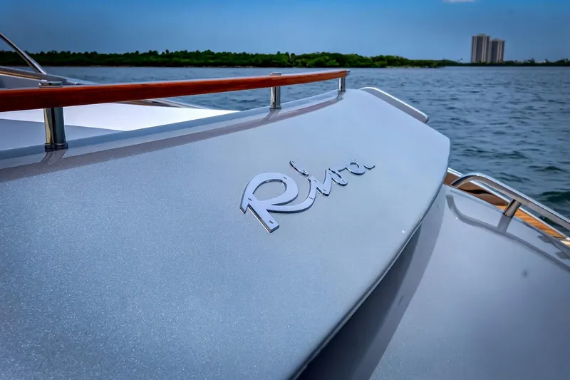 Slide: The Image of 2022 Riva 56' Rivale yacht on water, showcasing sleek design and logo detail. - 10