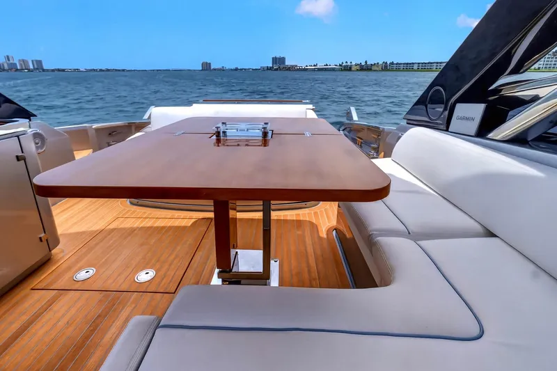 Slide: The Image of Luxurious 2022 Riva 56' Rivale yacht deck with elegant seating and wooden table. - 11