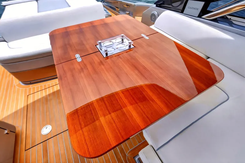 Slide: The Image of Luxurious wooden table on 2022 Riva 56' Rivale yacht, featuring elegant seating and modern design. - 12
