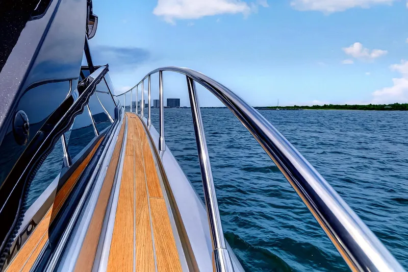 Slide: The Image of Side view of 2022 Riva 56' Rivale yacht cruising on open water. - 14