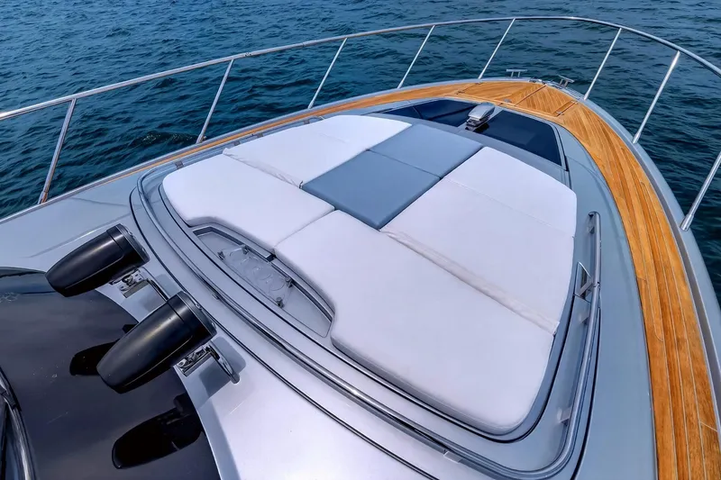 Slide: The Image of Luxurious 2022 Riva 56' Rivale yacht with sleek deck and sunbathing area on open water. - 16