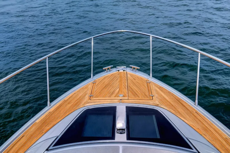 Slide: The Image of Bow view of 2022 Riva 56' Rivale yacht with teak deck on open water. - 18