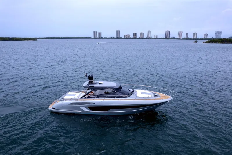 Slide: The Image of Luxury 2022 Riva 56' Rivale yacht cruising on open water. - 2