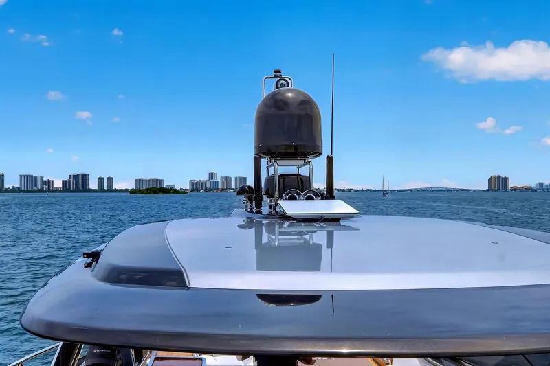 Slide: The Image of 2022 Riva 56' Rivale yacht on water with city skyline in background. - 20