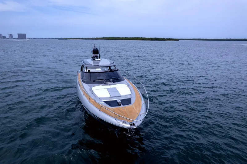 Slide: The Image of 2022 Riva 56' Rivale yacht cruising on open water under a clear sky. - 3