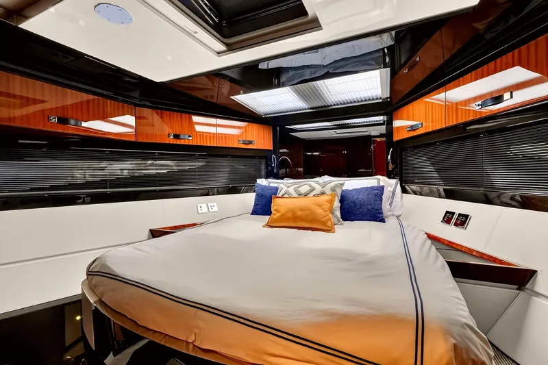 Slide: The Image of Luxurious 2022 Riva 56' Rivale yacht bedroom with modern design and plush bedding. - 56