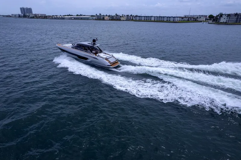 Slide: The Image of 2022 Riva 56' Rivale yacht cruising on open water, leaving a wake behind. - 64