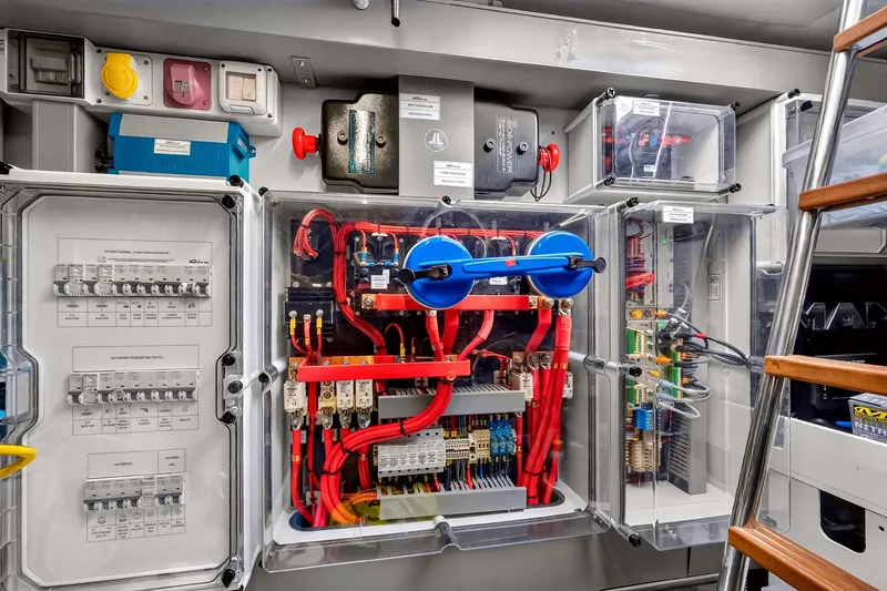 Slide: The Image of Electrical panel of 2022 Riva 56' Rivale yacht, showcasing wiring and circuit breakers. - 69