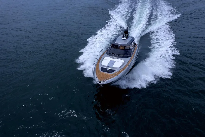 Slide: The Image of 2022 Riva 56' Rivale yacht cruising on open water, showcasing sleek design and powerful performance. - 7