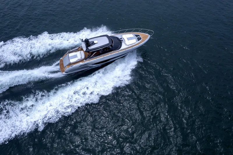 Slide: The Image of 2022 Riva 56' Rivale yacht cruising on open water, aerial view. - 9