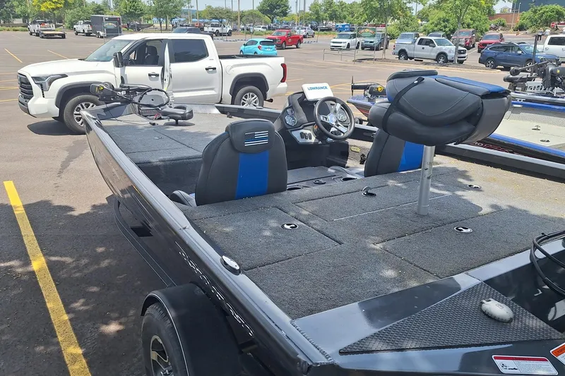 Slide: The Image of 2021 Boomeranger RT188P boat in parking lot, near white pickup truck. - 1