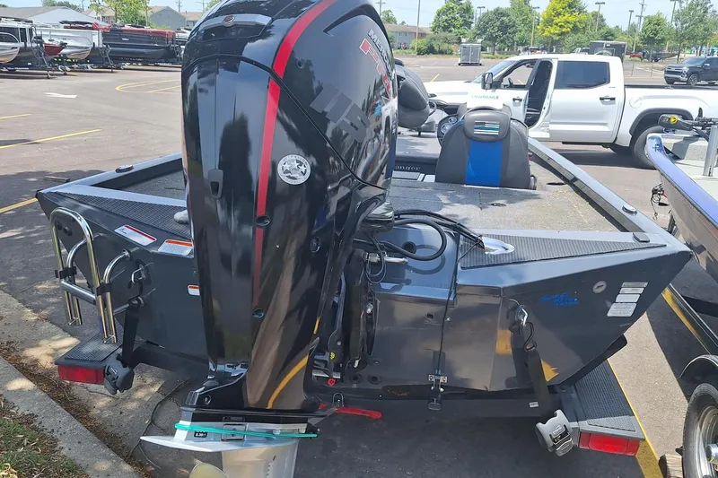 Slide: The Image of Boomeranger RT188P 2021 boat with powerful outboard motor in a parking lot. - 4