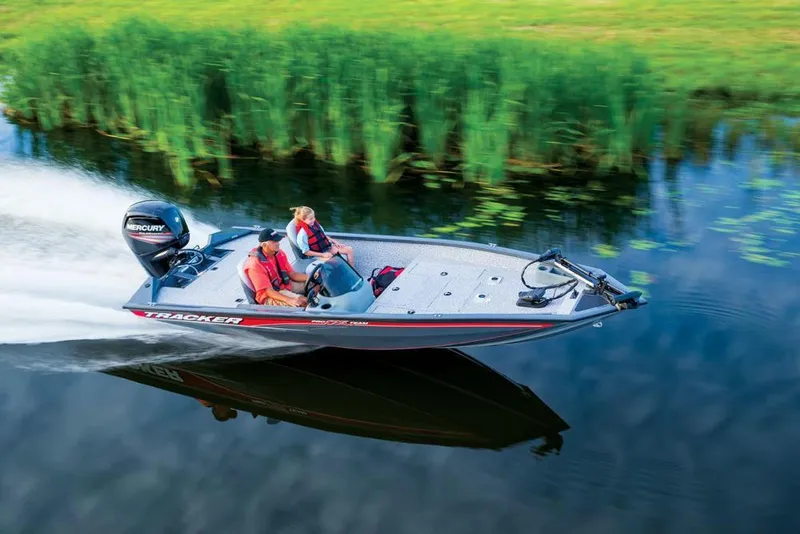 Slide: The Image of A boat speeds along calm water, surrounded by lush green vegetation. - 13