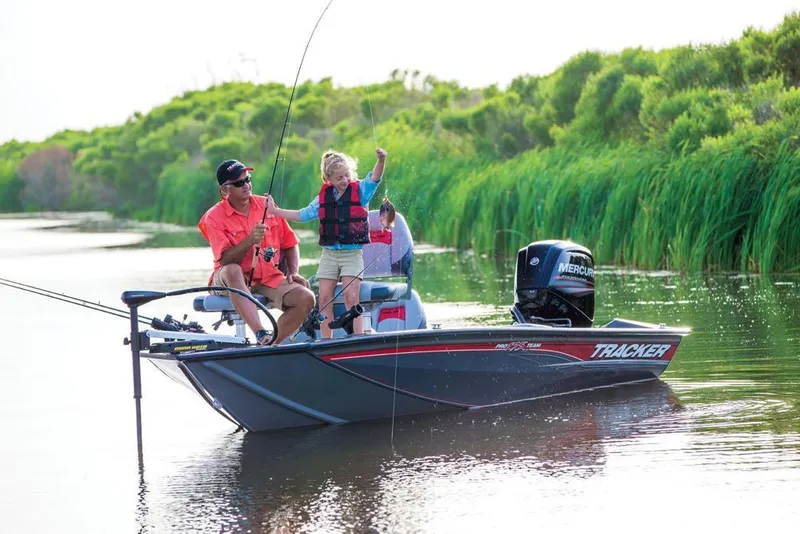 Slide: The Image of A man and child fishing on a Tracker boat in a calm river. - 17