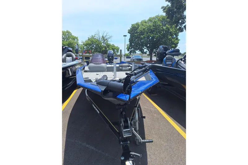 Slide: The Image of 2016 Tracker Pro Team 175 TF boat parked outdoors on a sunny day. - 2