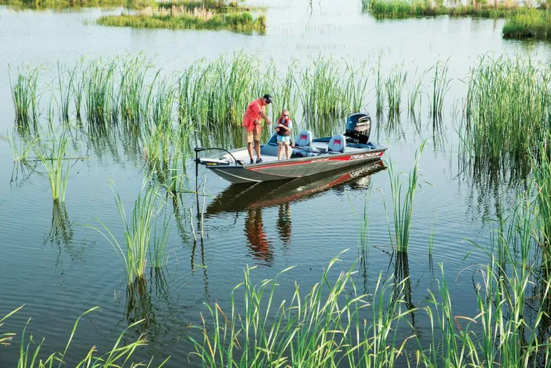 Slide: The Image of Two people fishing on a boat in a reed-filled waterway. - 21