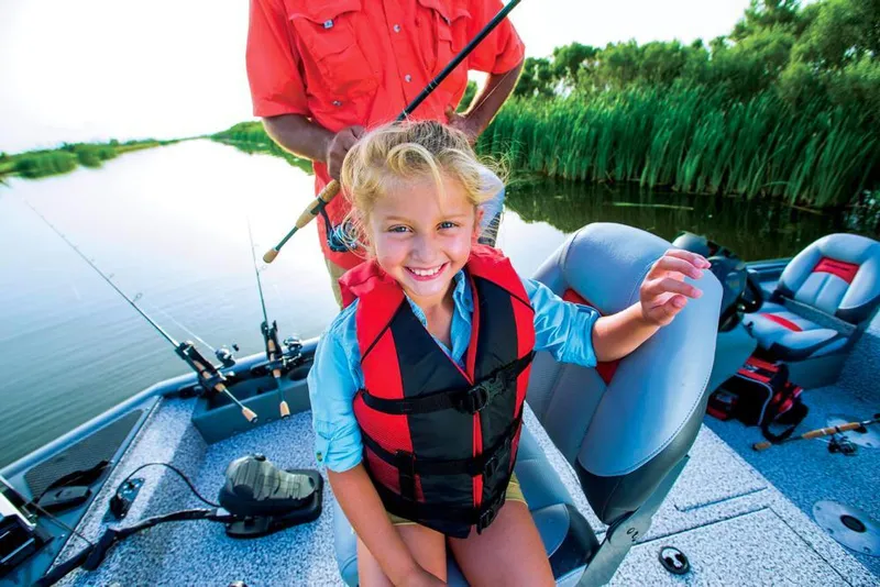 Slide: The Image of Girl in life jacket on a boat, surrounded by water and reeds. - 31