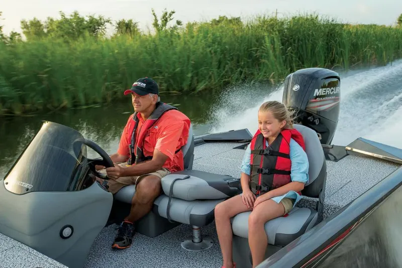 Slide: The Image of A man and a girl ride in a motorboat on a river. - 32