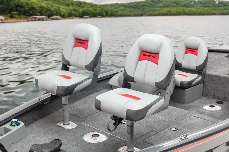 Slide: The Image of Tracker Pro Team 175 TF boat with gray and red seats on a lake. - 38