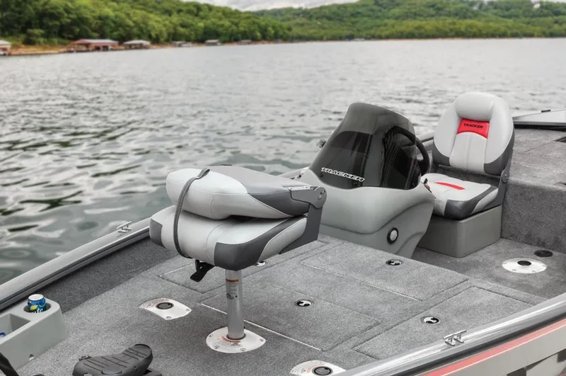 Slide: The Image of A gray fishing boat with cushioned seats on a calm lake. - 40