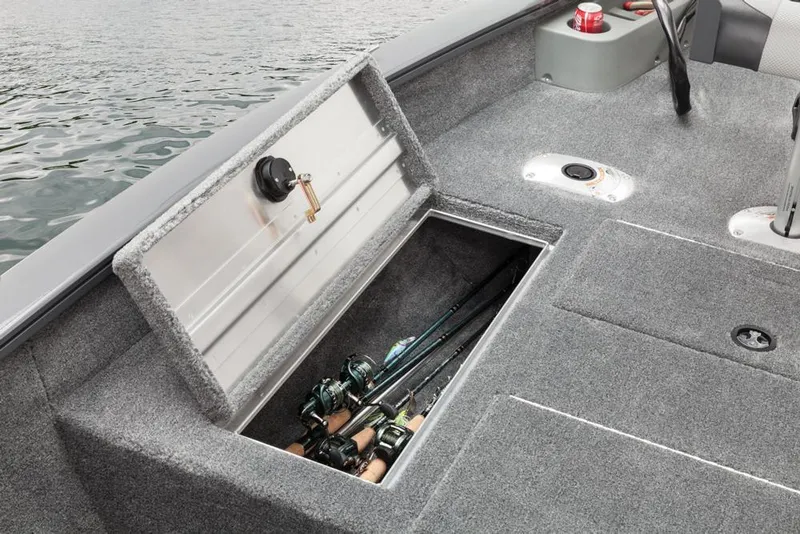 Slide: The Image of Fishing rods in a storage compartment of a gray boat on calm water. - 41