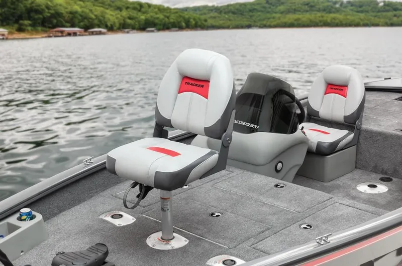 Slide: The Image of A gray boat with two cushioned seats on a calm lake. - 43