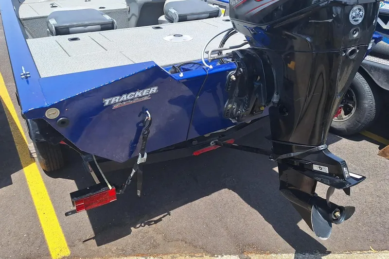 Slide: The Image of 2016 Tracker Pro Team 175 TF boat with outboard motor, parked on asphalt. - 7