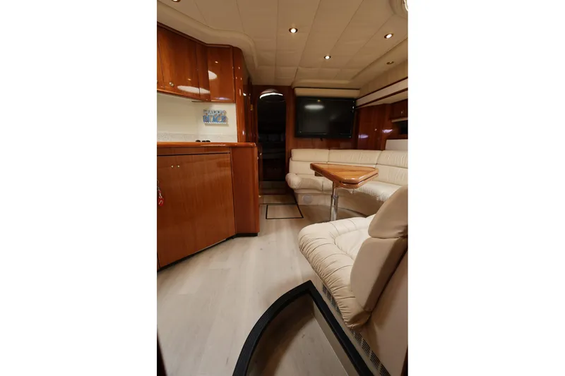 Slide: The Image of Luxurious interior of 1999 Neptunus 54 Express yacht with elegant seating and wood finishes. - 13