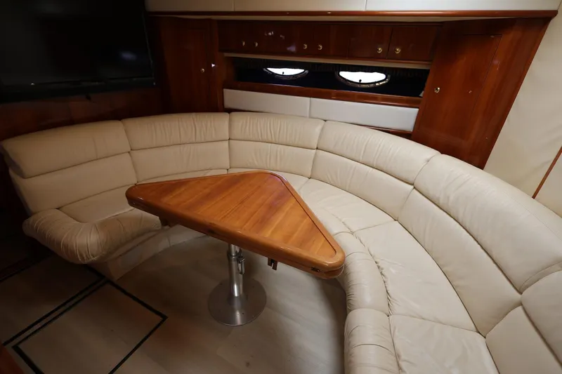Slide: The Image of Luxurious interior of 1999 Neptunus 54 Express yacht with leather seating and wooden table. - 14