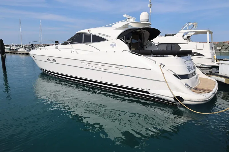 Slide: The Image of 1999 Neptunus 54 Express yacht docked in a marina, side view. - 3