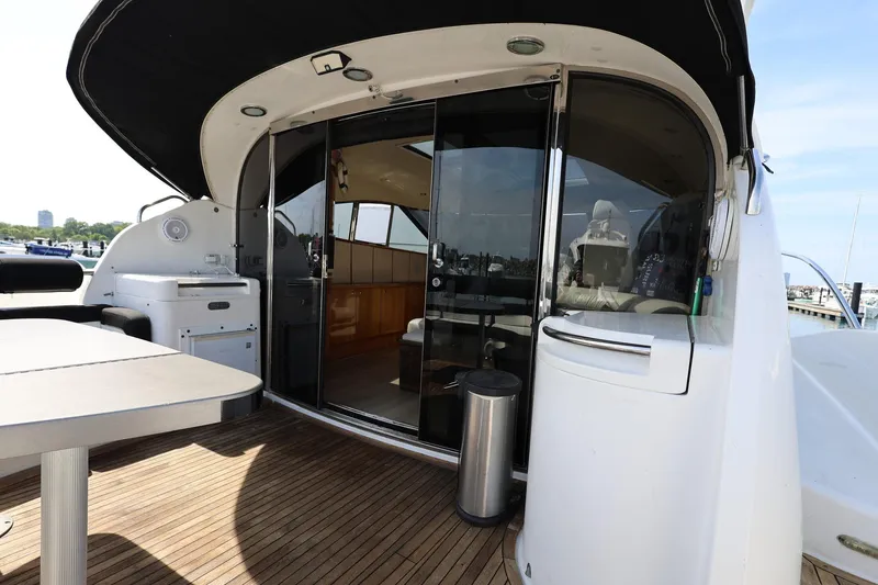 Slide: The Image of 1999 Neptunus 54 Express yacht with open deck and sliding glass doors. - 7