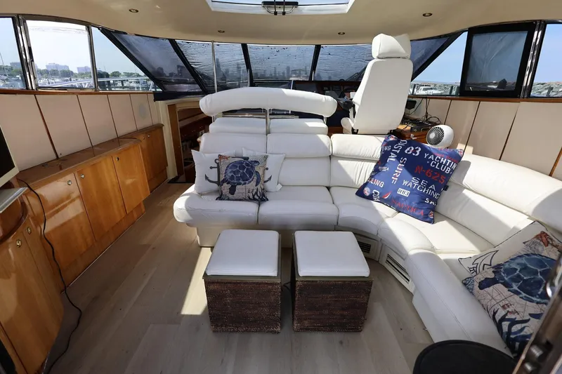Slide: The Image of Luxurious interior of 1999 Neptunus 54 Express yacht with white leather seating and nautical decor. - 8