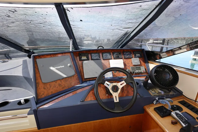 Slide: The Image of Cockpit of 1999 Neptunus 54 Express yacht with steering wheel and navigation equipment. - 9