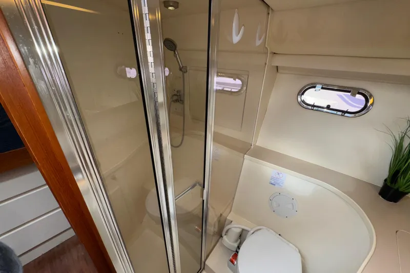 Slide: The Image of Bathroom interior of 1996 Carver 370 Voyager yacht with shower and porthole window. - 28
