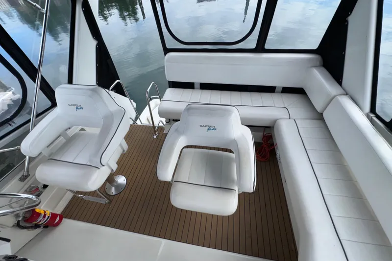 Slide: The Image of 1996 Carver 370 Voyager interior with white seating and wooden flooring. - 29