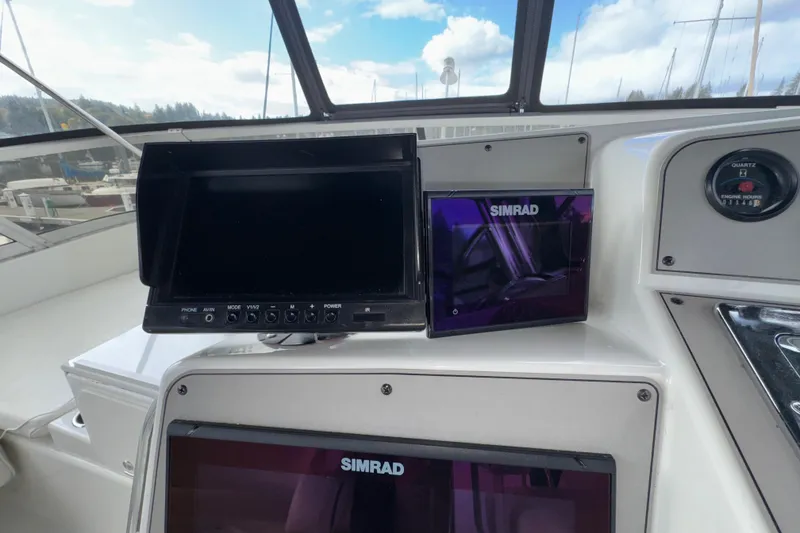 Slide: The Image of 1996 Carver 370 Voyager helm with Simrad navigation displays and engine hour gauge. - 36