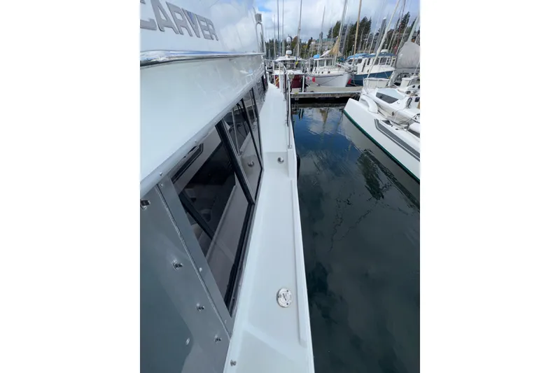 Slide: The Image of 1996 Carver 370 Voyager docked at marina, side view with reflections on water. - 43